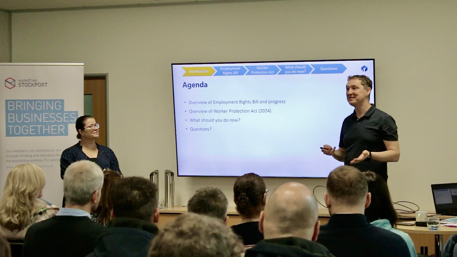 Rob and Nicci presenting the agenda slide at a previous Cornerstone employment law briefing