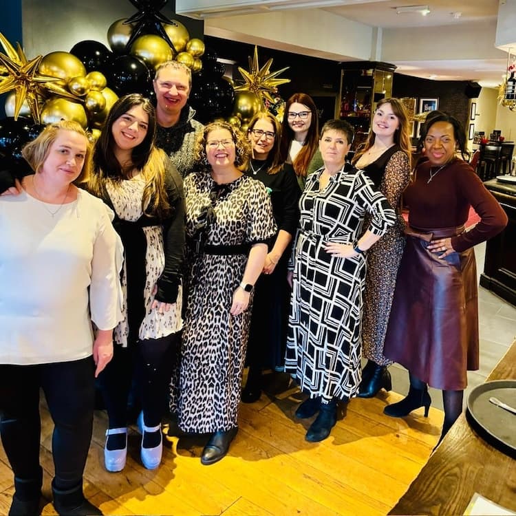 Cornerstone Resources team at their Christmas celebration party in a restaurant