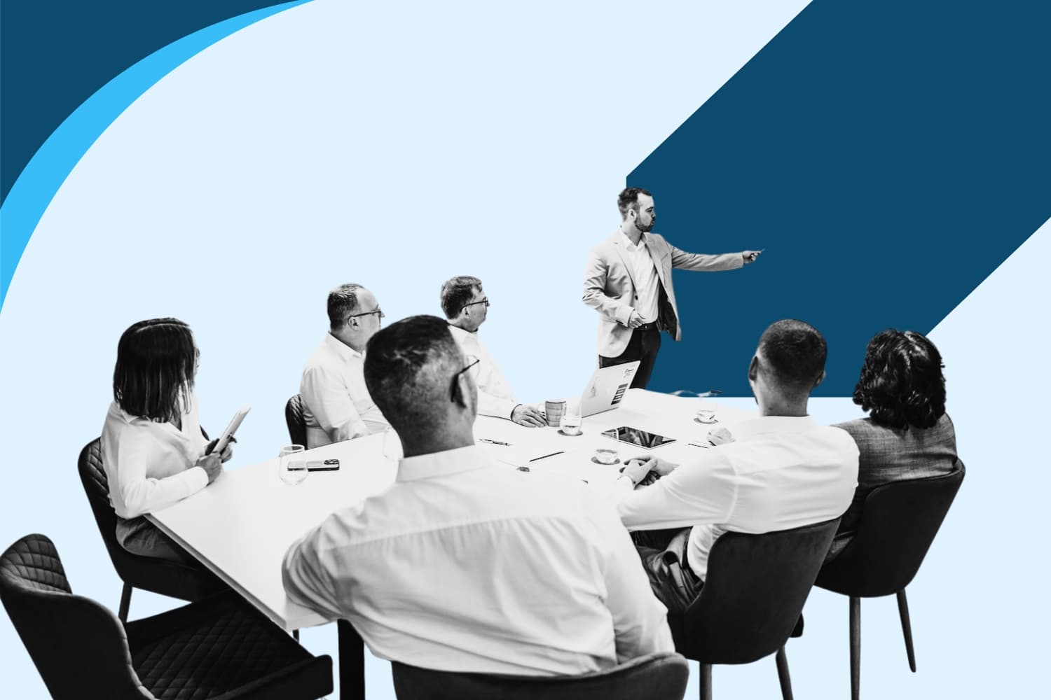 Male instructor delivering training to a group of professionals around a table