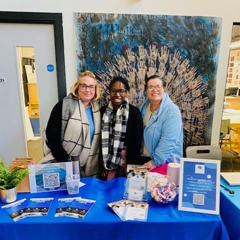Nicci and Heather at The Pledge on a branded Cornerstone Resources table